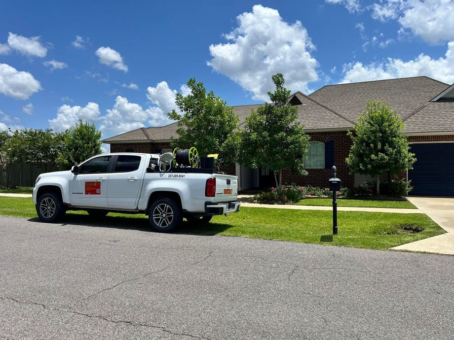 A white truck is parked in front of a house.