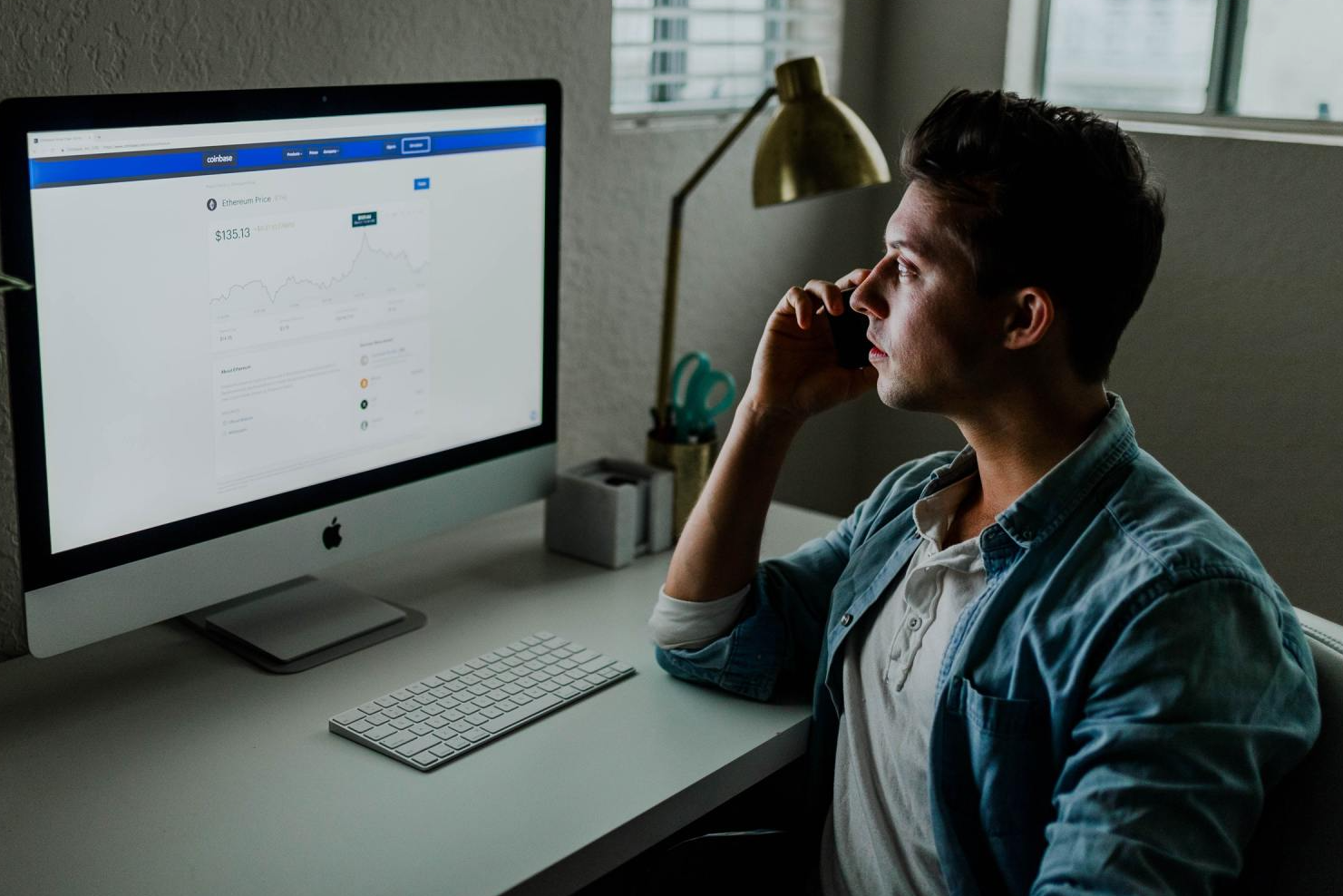 A Virtual Assistant is sitting at a desk looking at a computer screen.