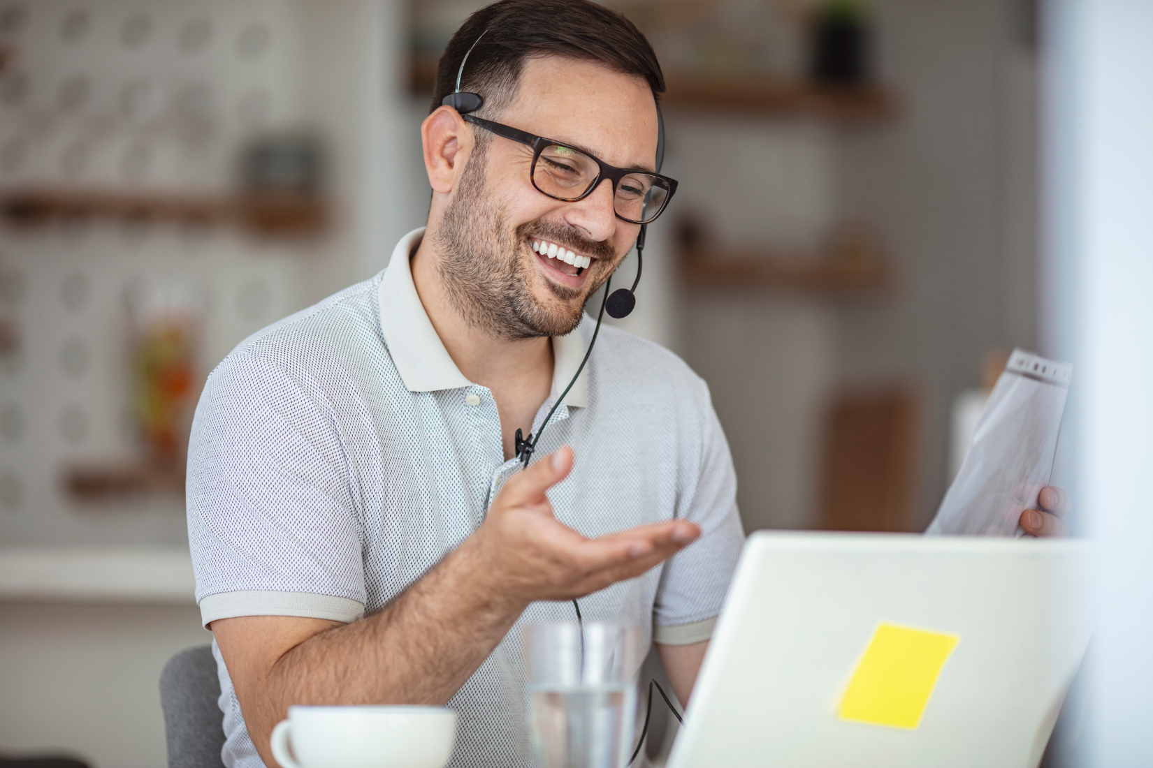 A Virtual Assistant wearing a headset is sitting in front of a laptop computer.