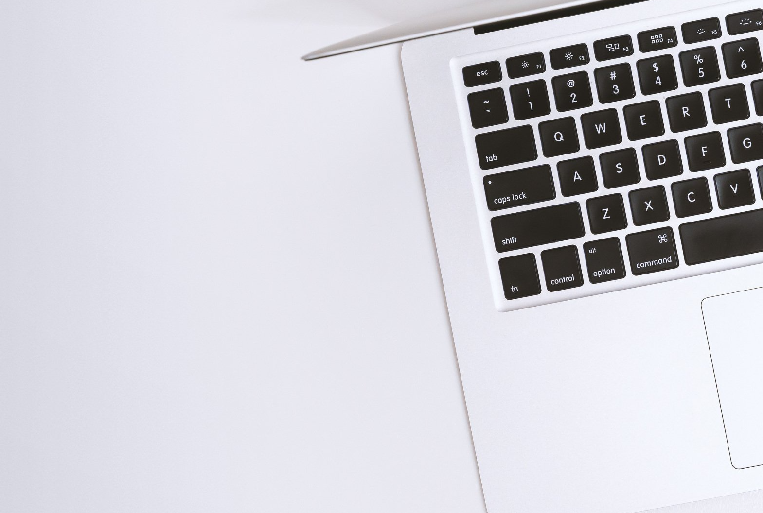 A laptop computer is sitting on a white table.