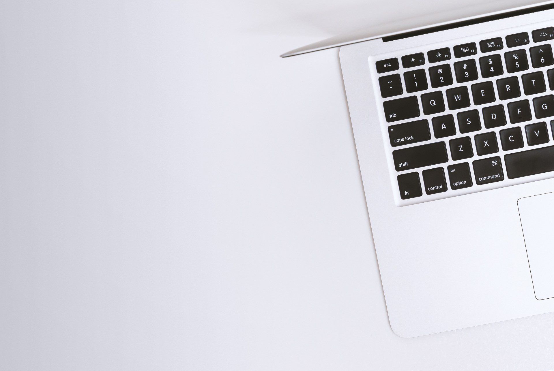 A laptop computer is sitting on a white table.