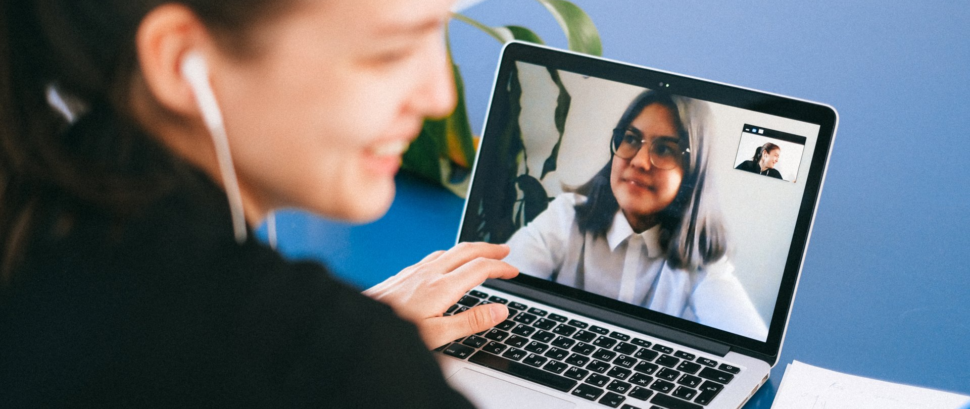 A Virtual Assistant is having a video call on her laptop.