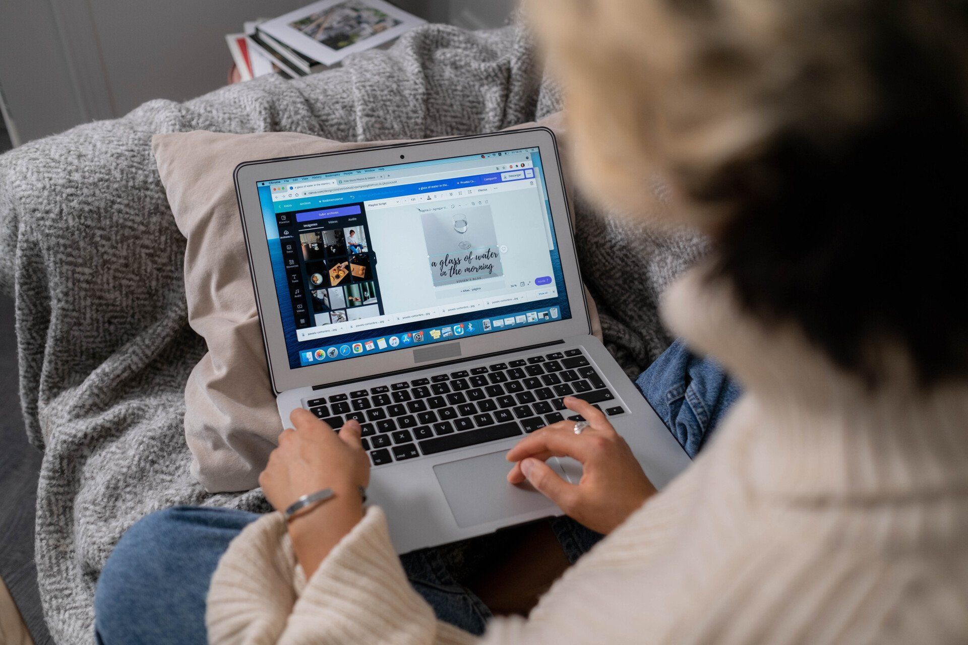 A Virtual Assistant is sitting on a couch using a laptop computer.
