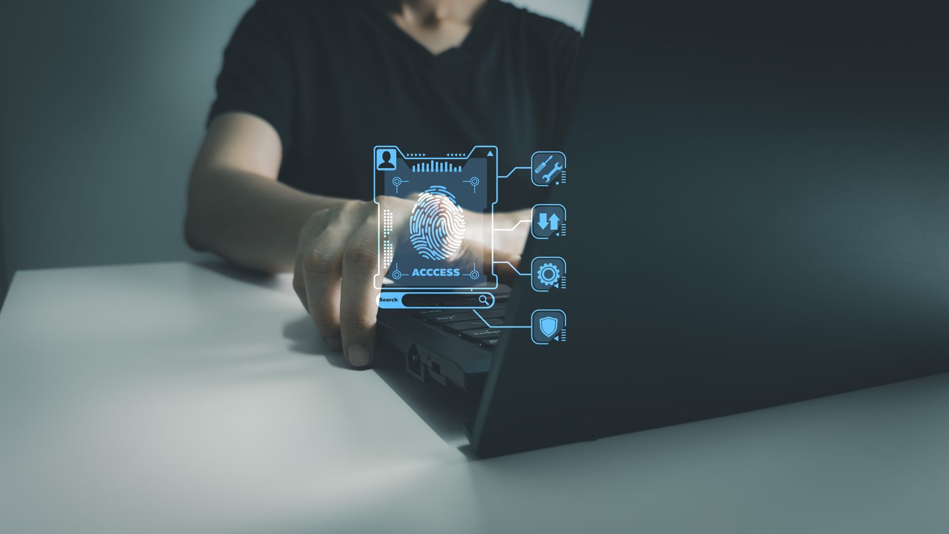Hand placing a finger on a fingerprint scanner, device on a wooden surface, red light lit.