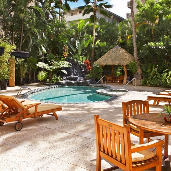 A large swimming pool surrounded by chairs and tables