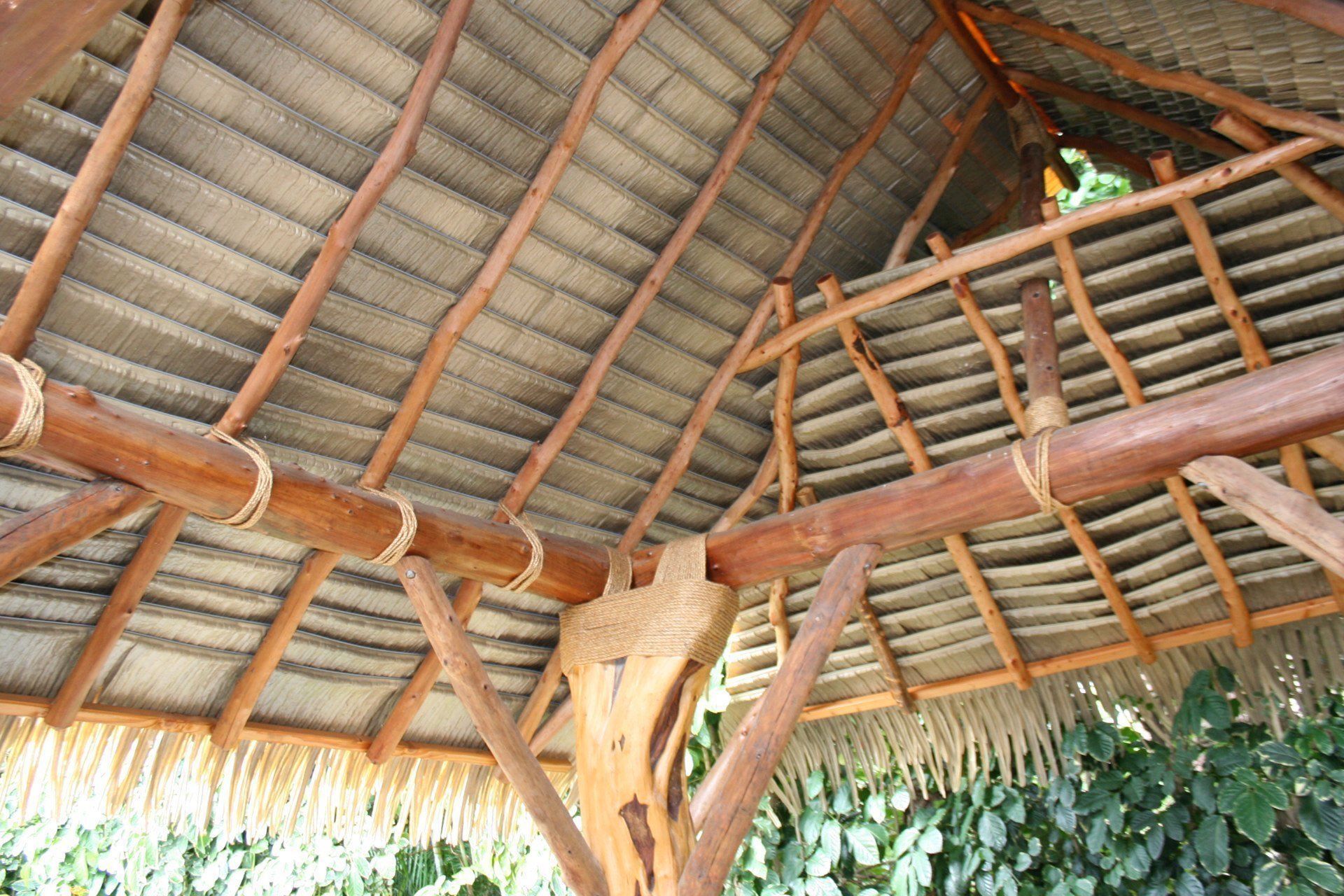 A wooden structure with a thatched roof