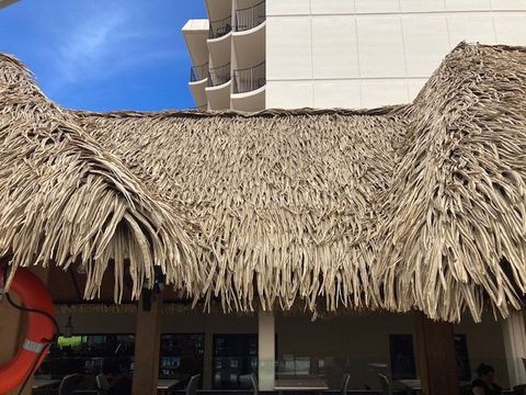 A thatched roof with a life preserver on it