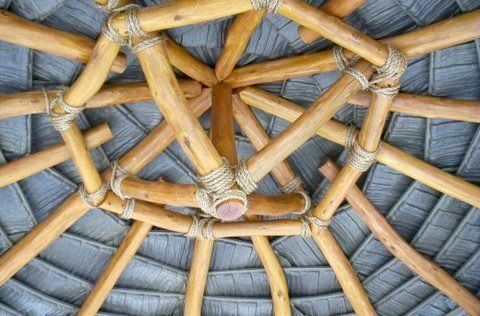 A close up of a roof made of bamboo and rope.