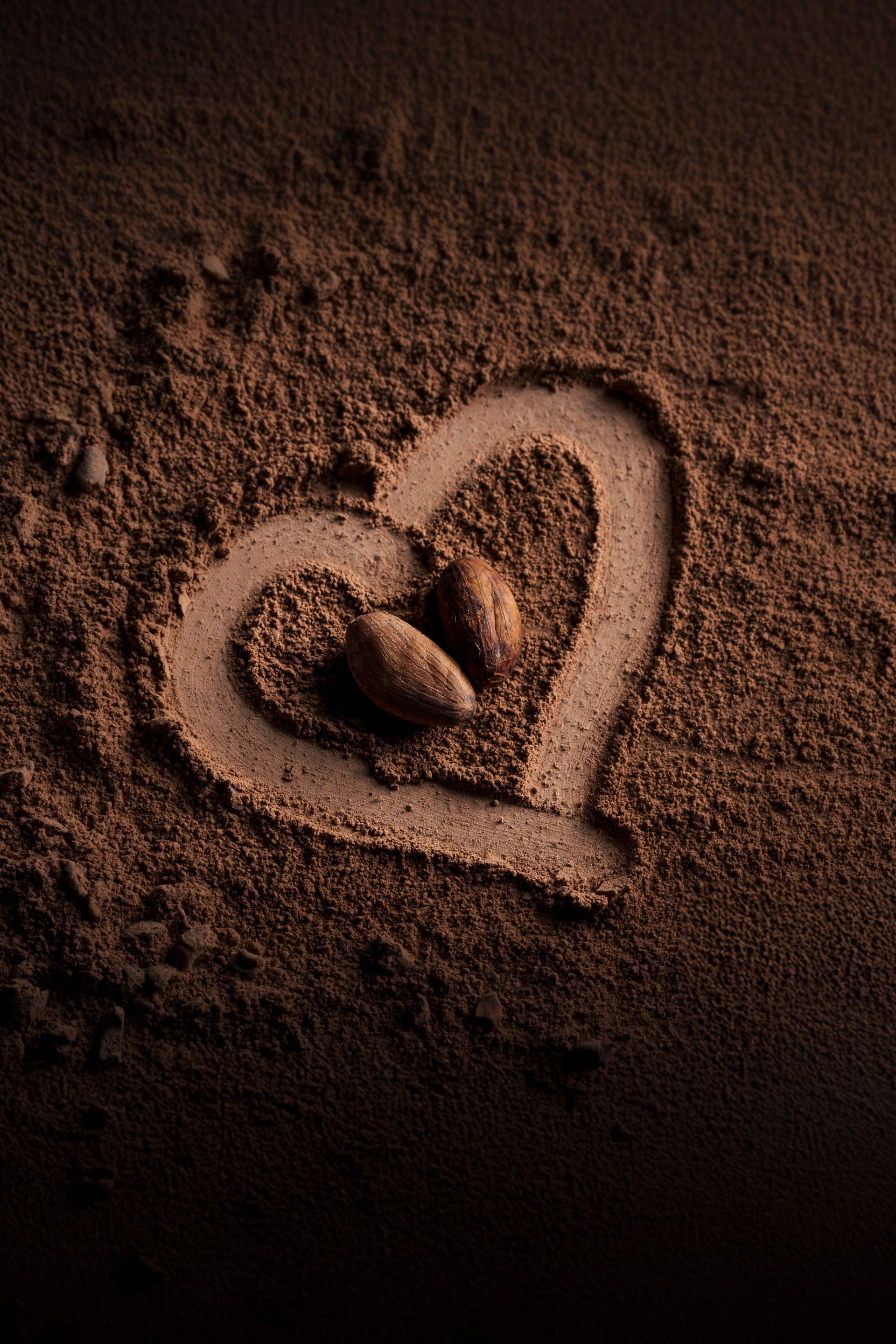 A heart is drawn in a pile of brown powder