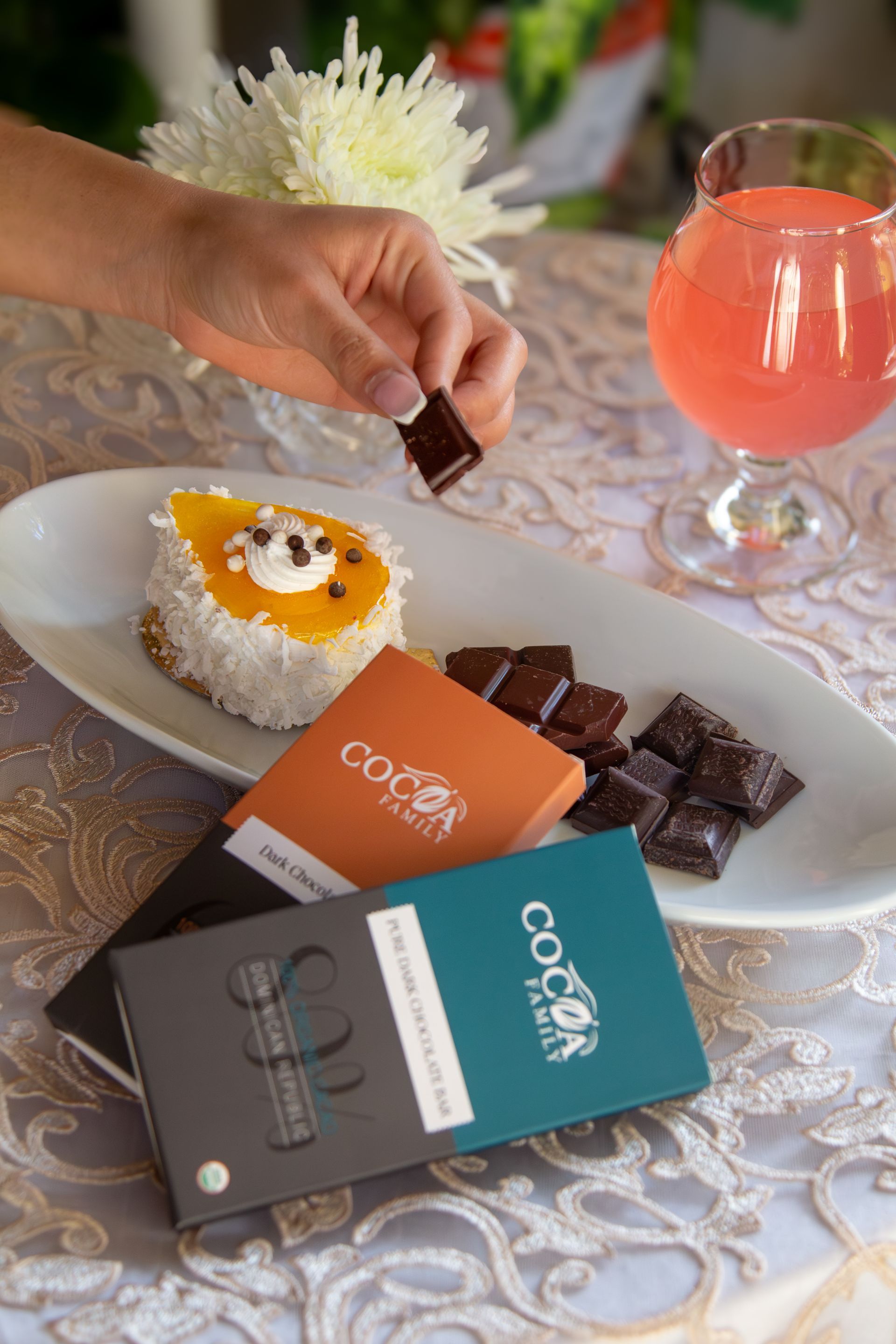 A person is dipping a piece of chocolate into a cocoa bar