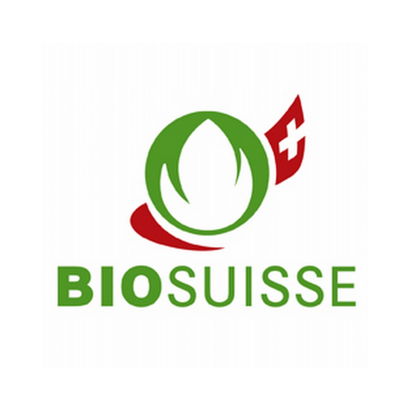 A logo for biosuisse with a green leaf and a red cross
