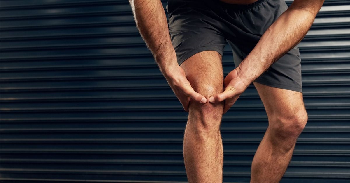 A man holding his knee to strengthen