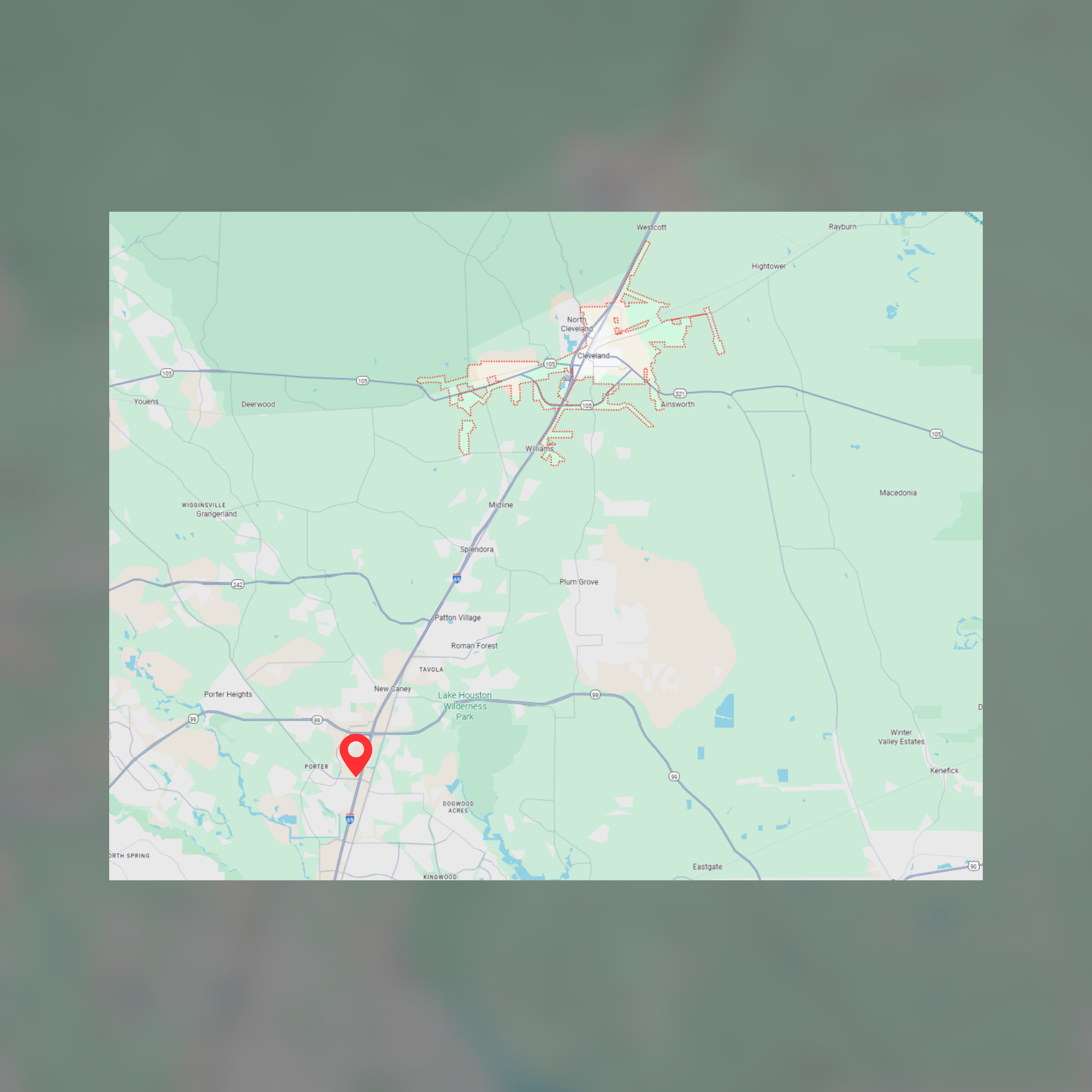 Map with a red location marker, showing a road and a town.