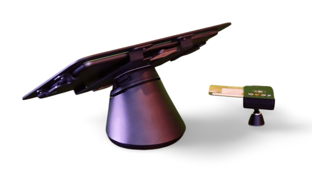 A tablet is sitting on a stand next to a key