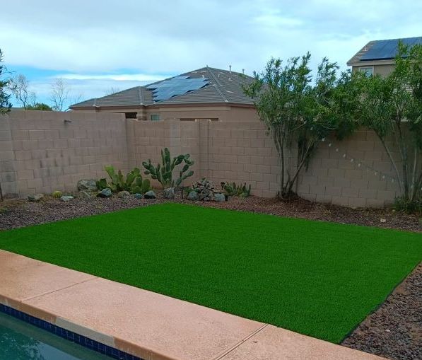 Newly laid astro turf next to the pool,  with bushes trimmed