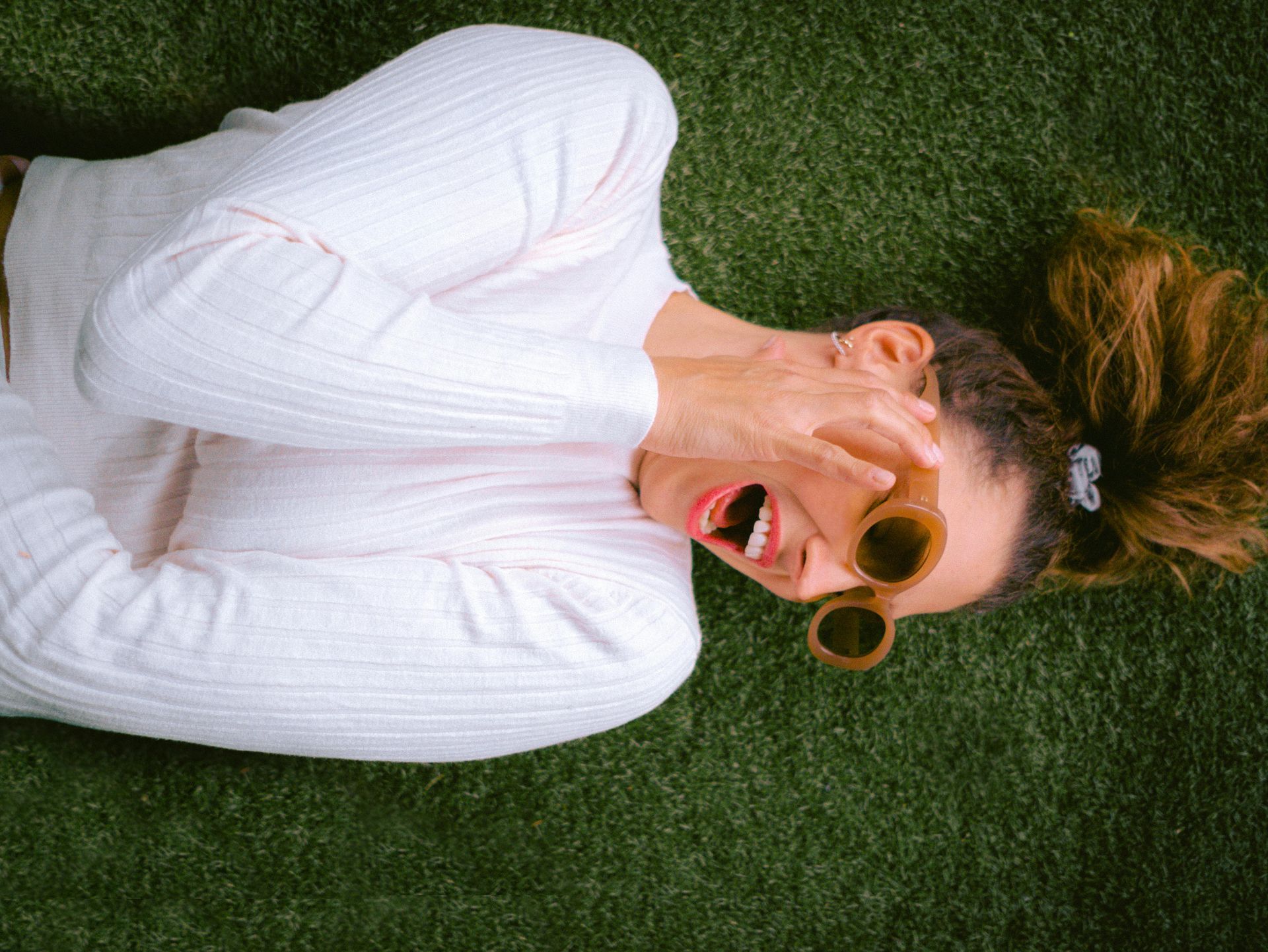 A woman lying on artificial turf