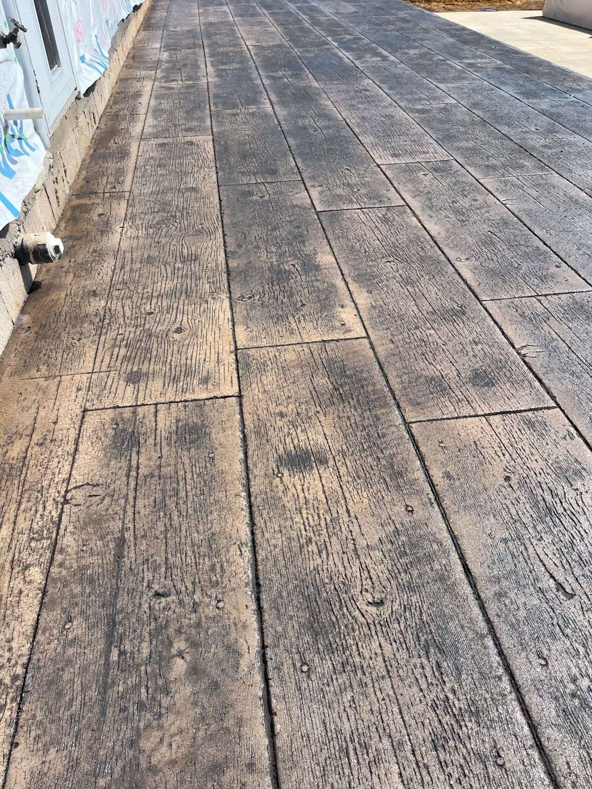 Stamped concrete pathway designed to look like weathered wood.