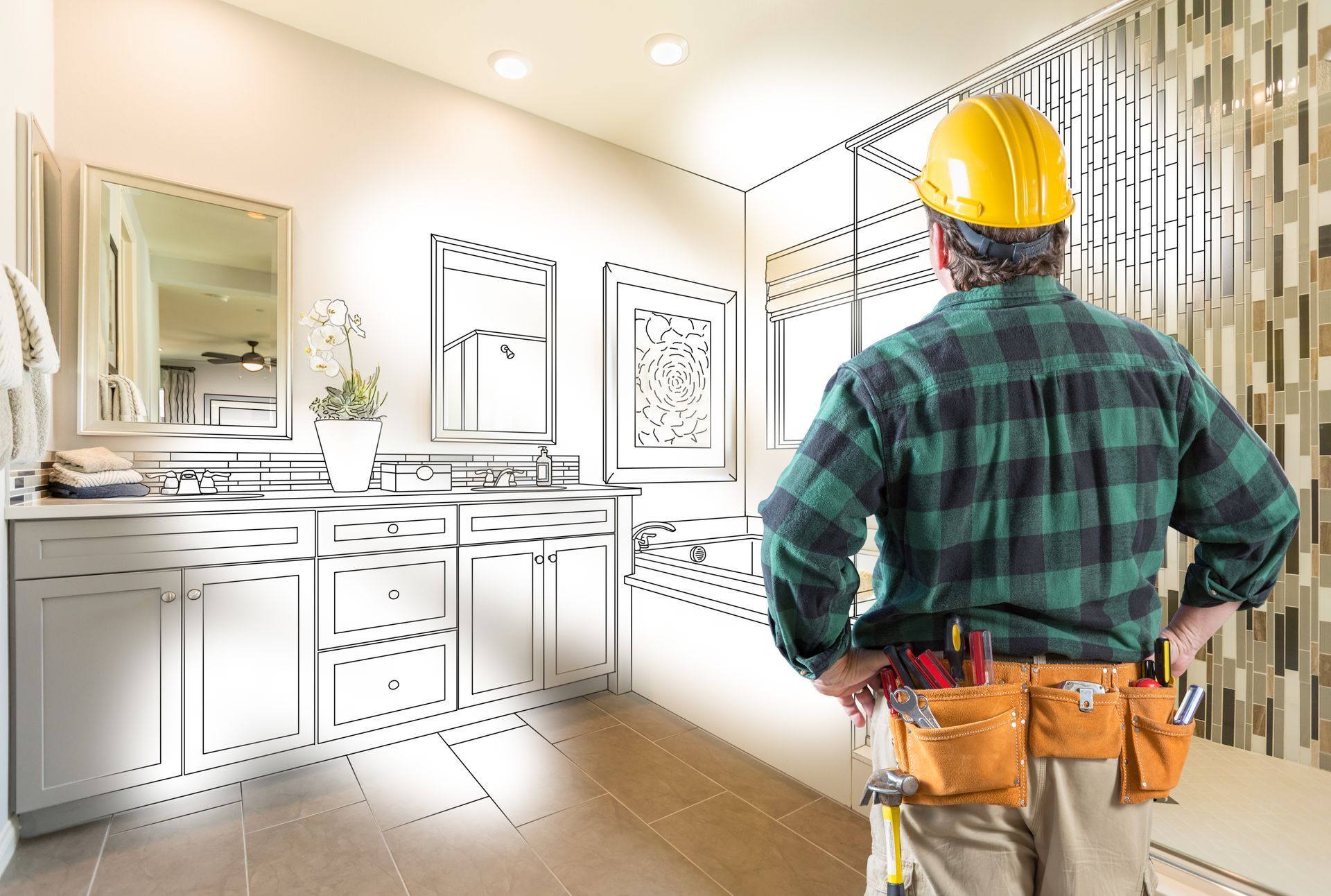 Builder in hard hat looking at bathroom renovation sketch.