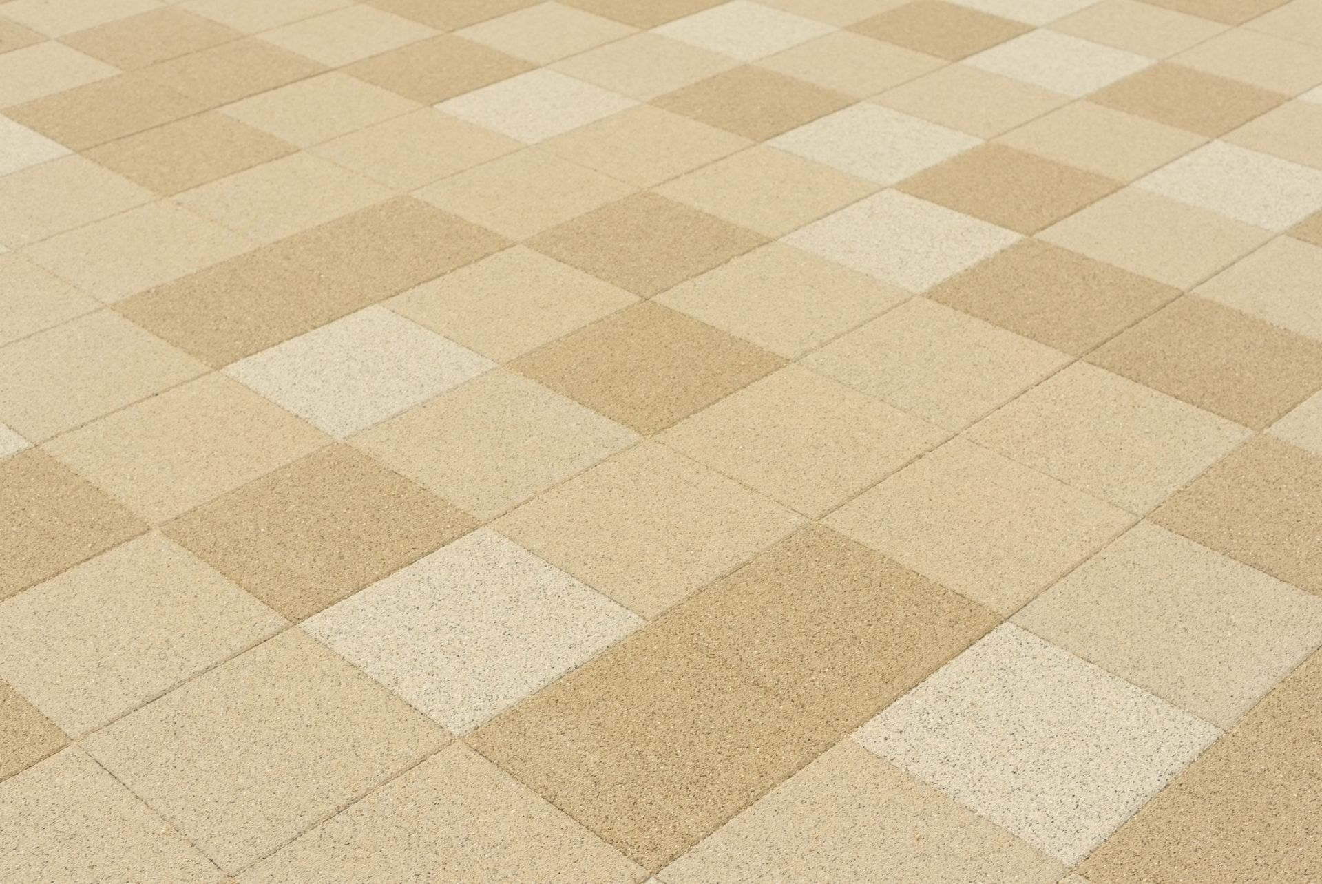 Tiled floor with a diamond pattern in shades of tan and light beige.