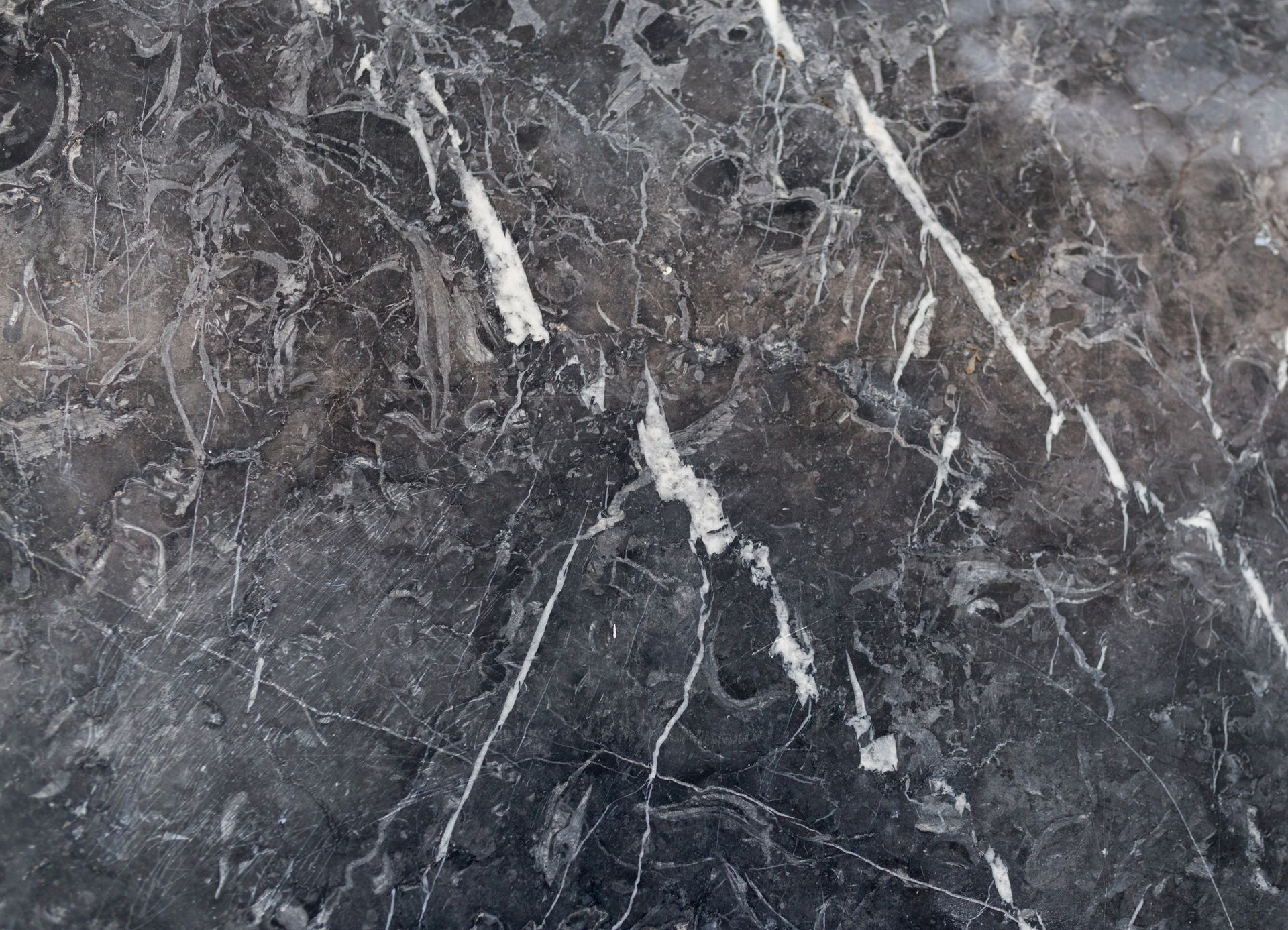 Dark gray marble with white veins running throughout.