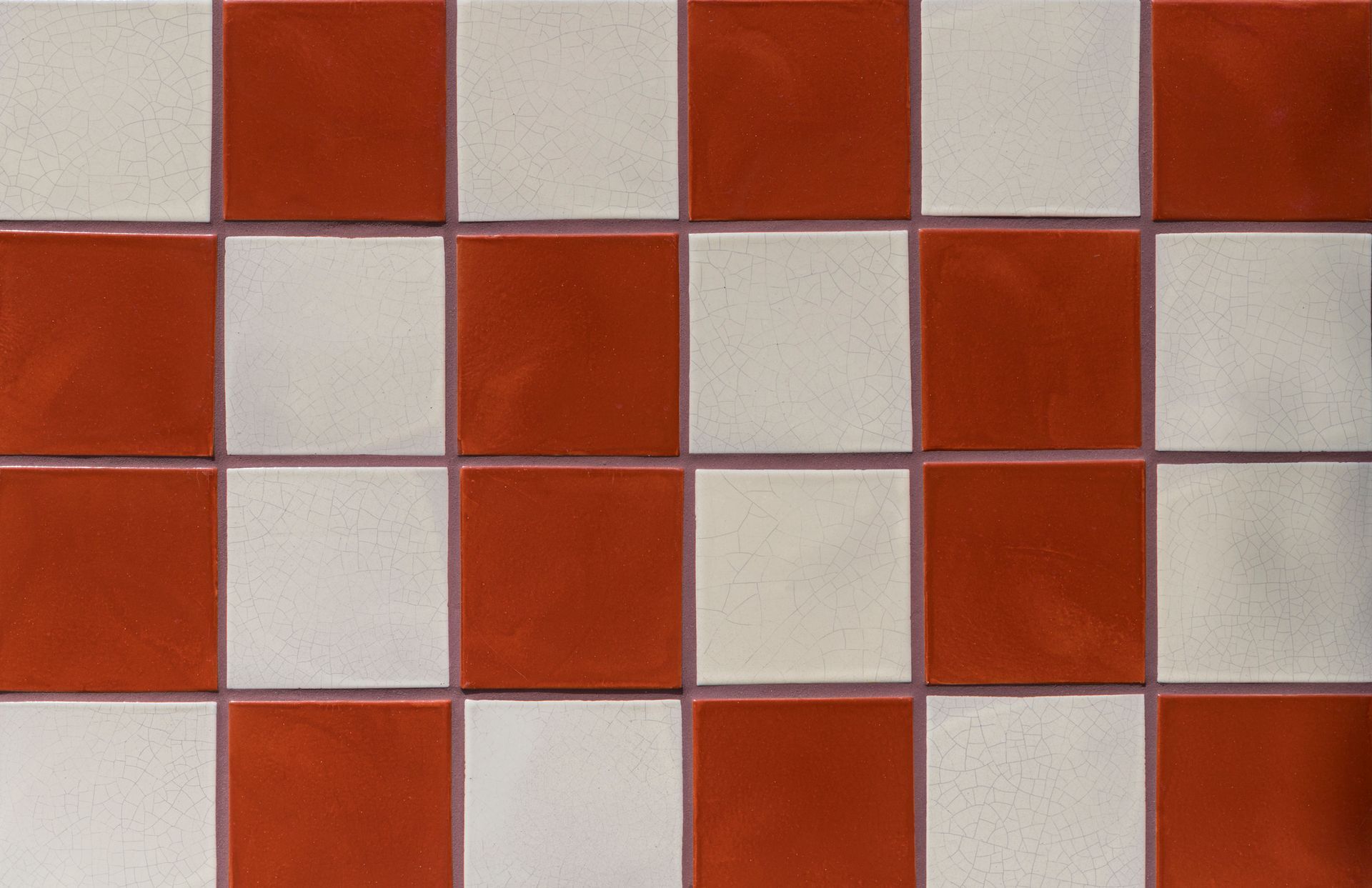 Red and white checkered square tile pattern.
