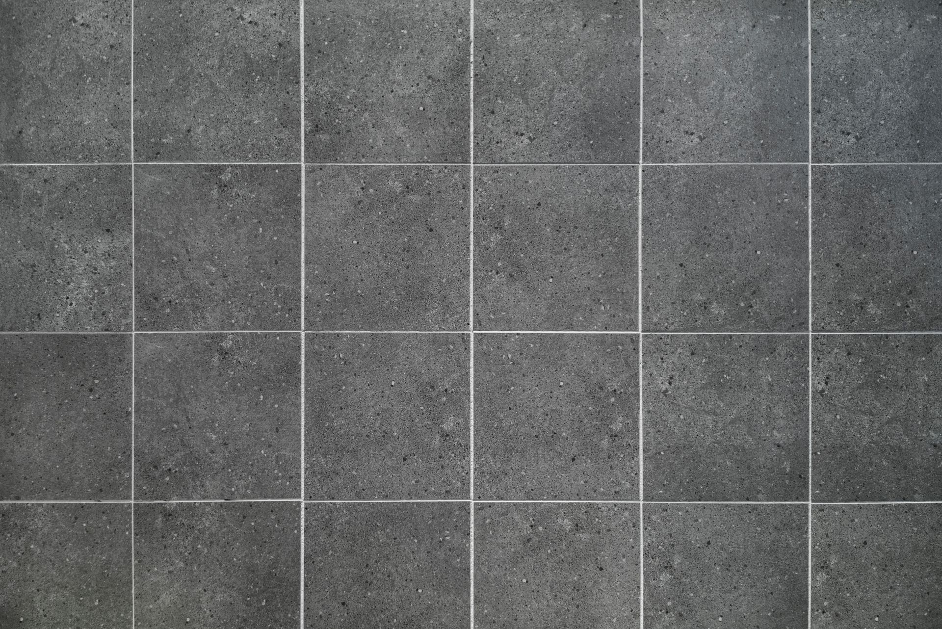 Dark gray square tiles with white grout lines.