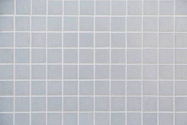 Gray square tile pattern with white grout lines.