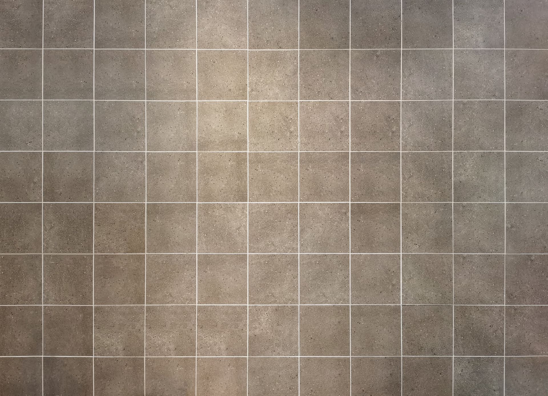 Gray tiled wall with white grout lines.