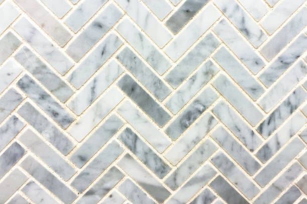 Herringbone pattern tile with gray and white marble.