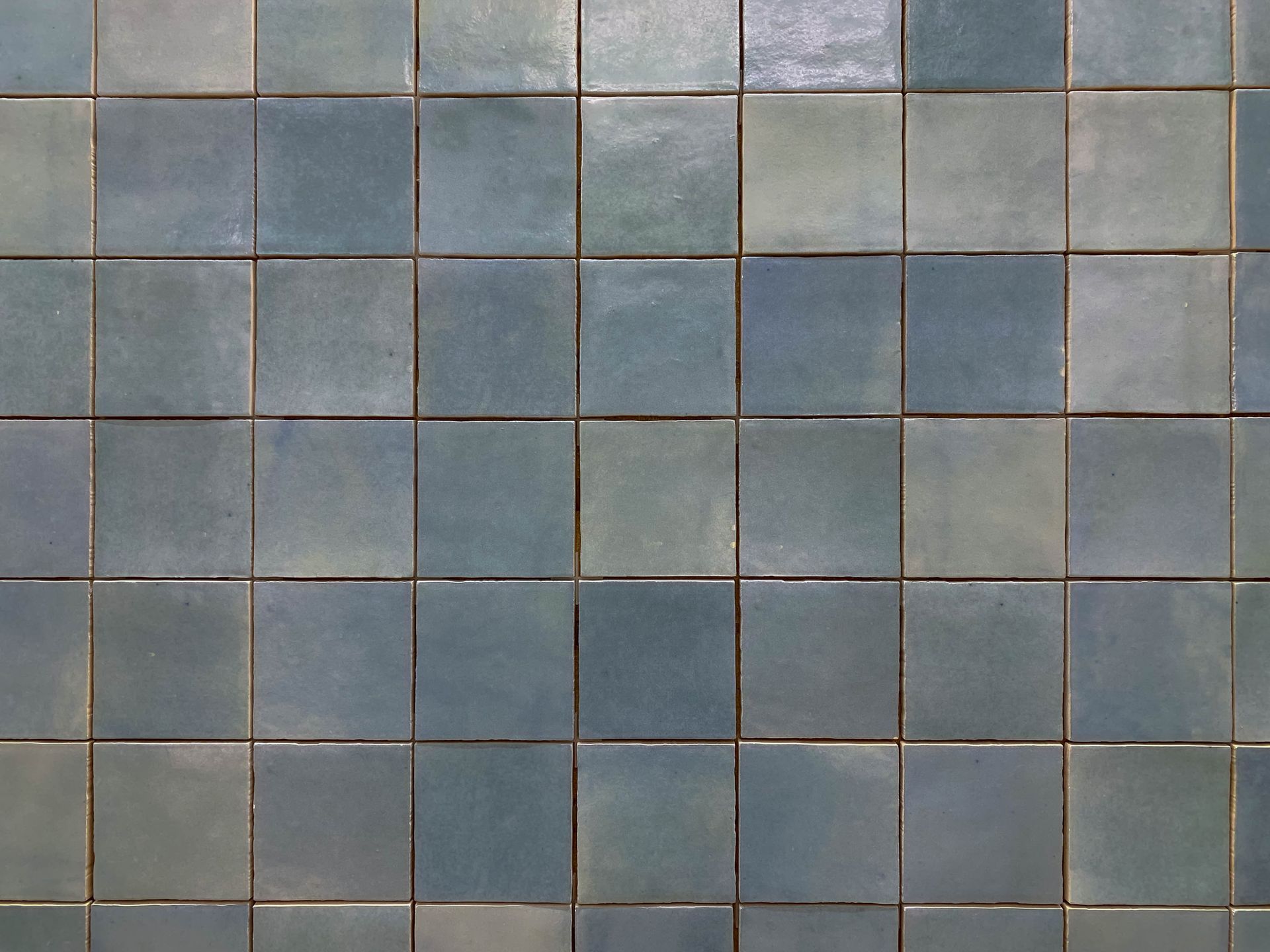 Blue square tiles with dark grout.