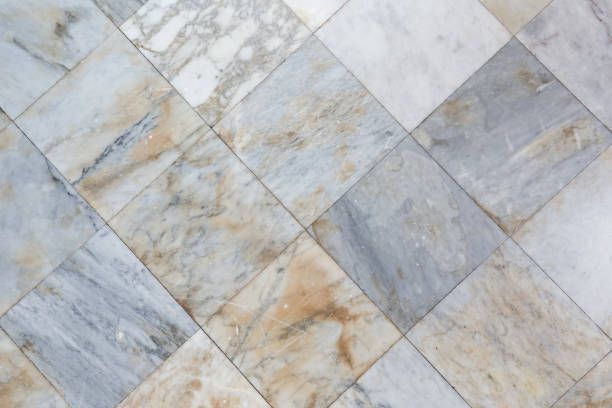 Diamond-patterned marble floor with gray, white, and tan swirls.