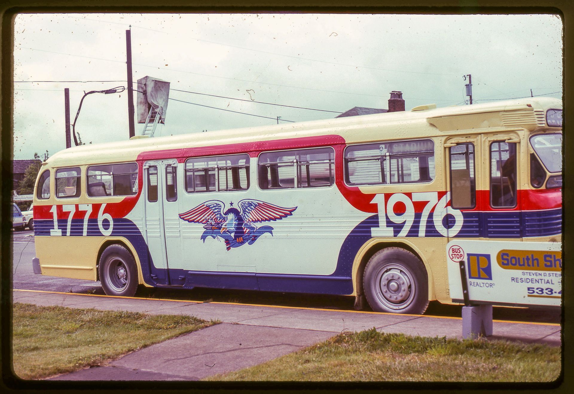 Photograph of a GHT bus with a classic American eagle painted on the side from 1976.