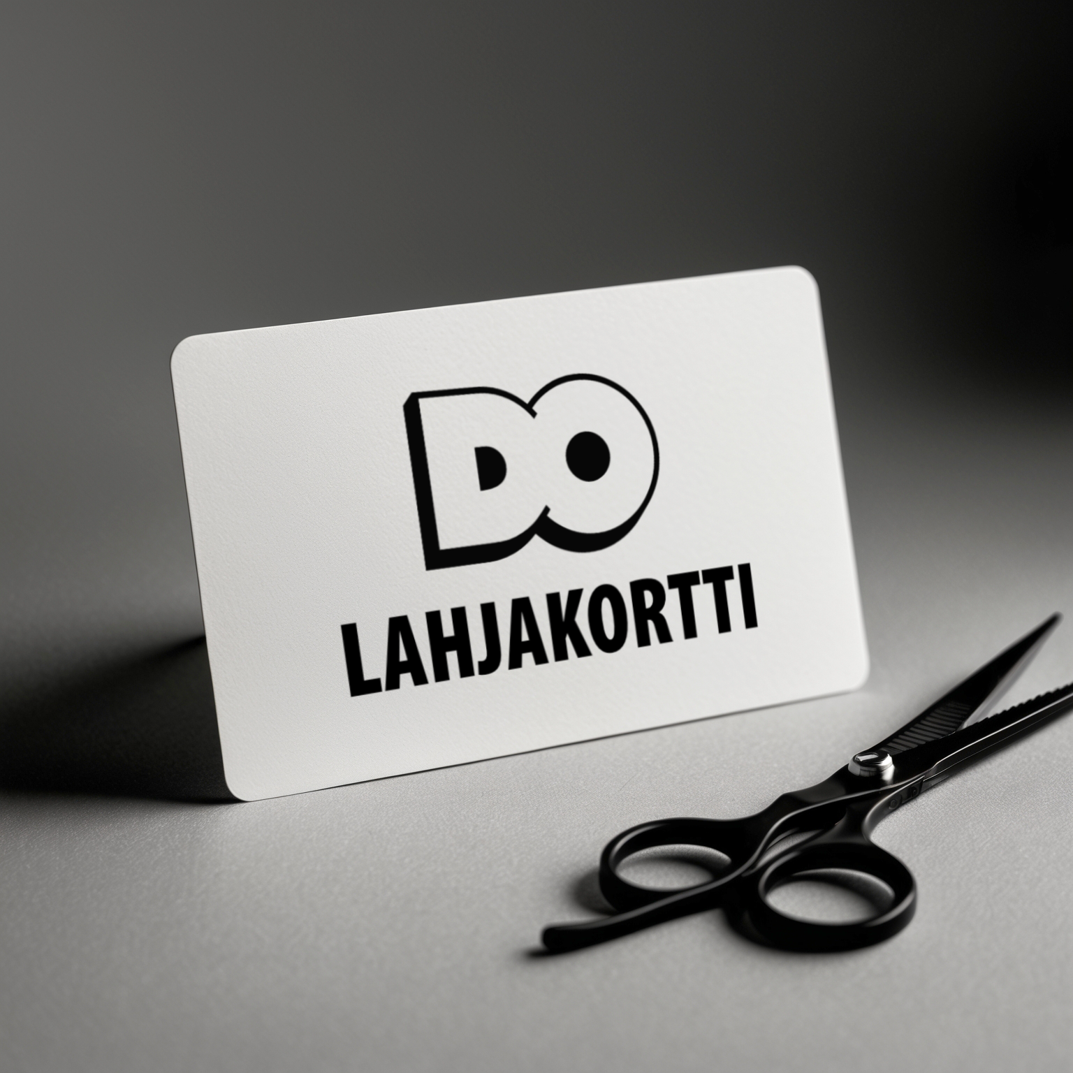 A white card that says do lahjakortti next to a pair of scissors