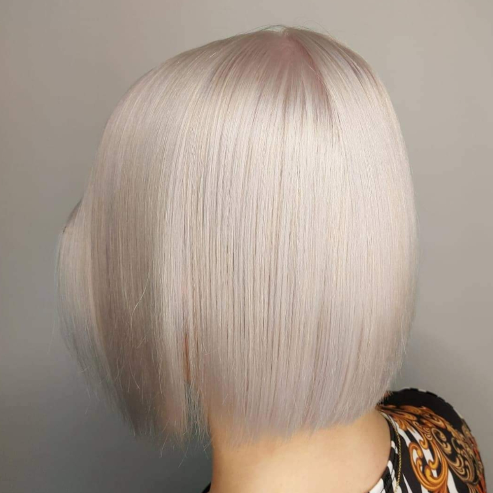 The back of a woman 's head with short white hair.