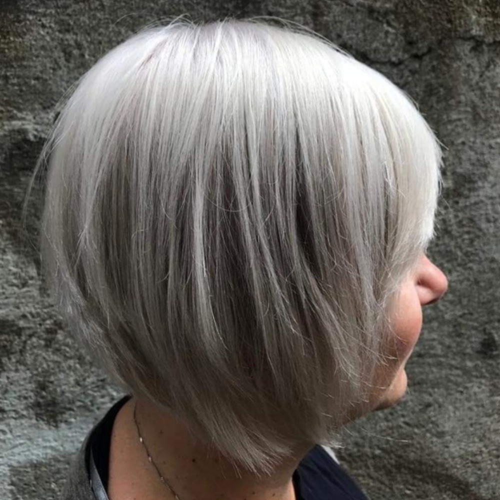 A woman with gray hair is wearing a bob hairstyle.