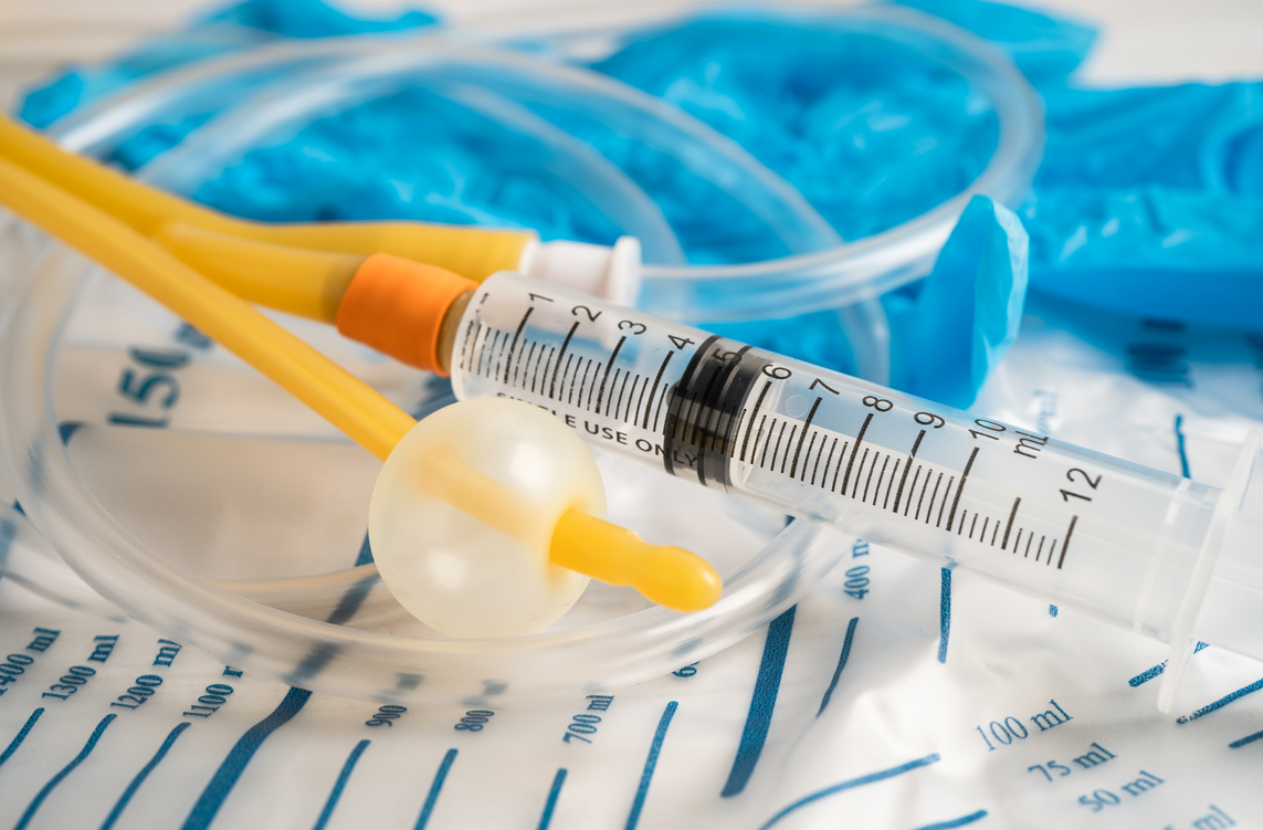 A syringe is sitting on top of a urine bag.