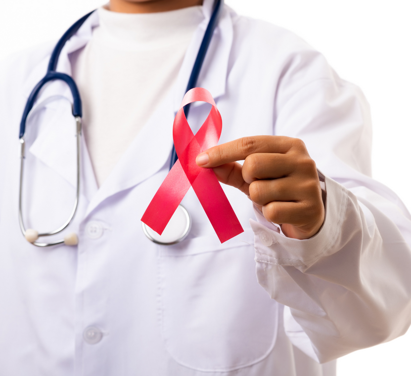 A doctor with a stethoscope around his neck is holding a red ribbon