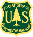 U.S. Forest Service shield logo in green, yellow, and gold with pine tree and USDA text