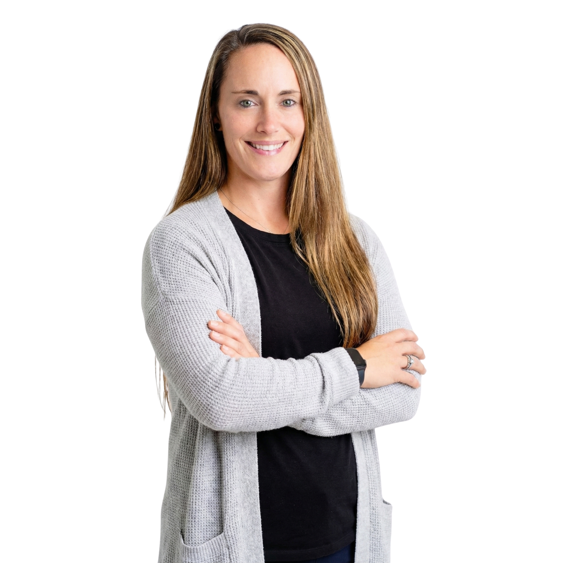 Woman with long brown hair, smiling, arms crossed, wearing gray cardigan over black shirt.