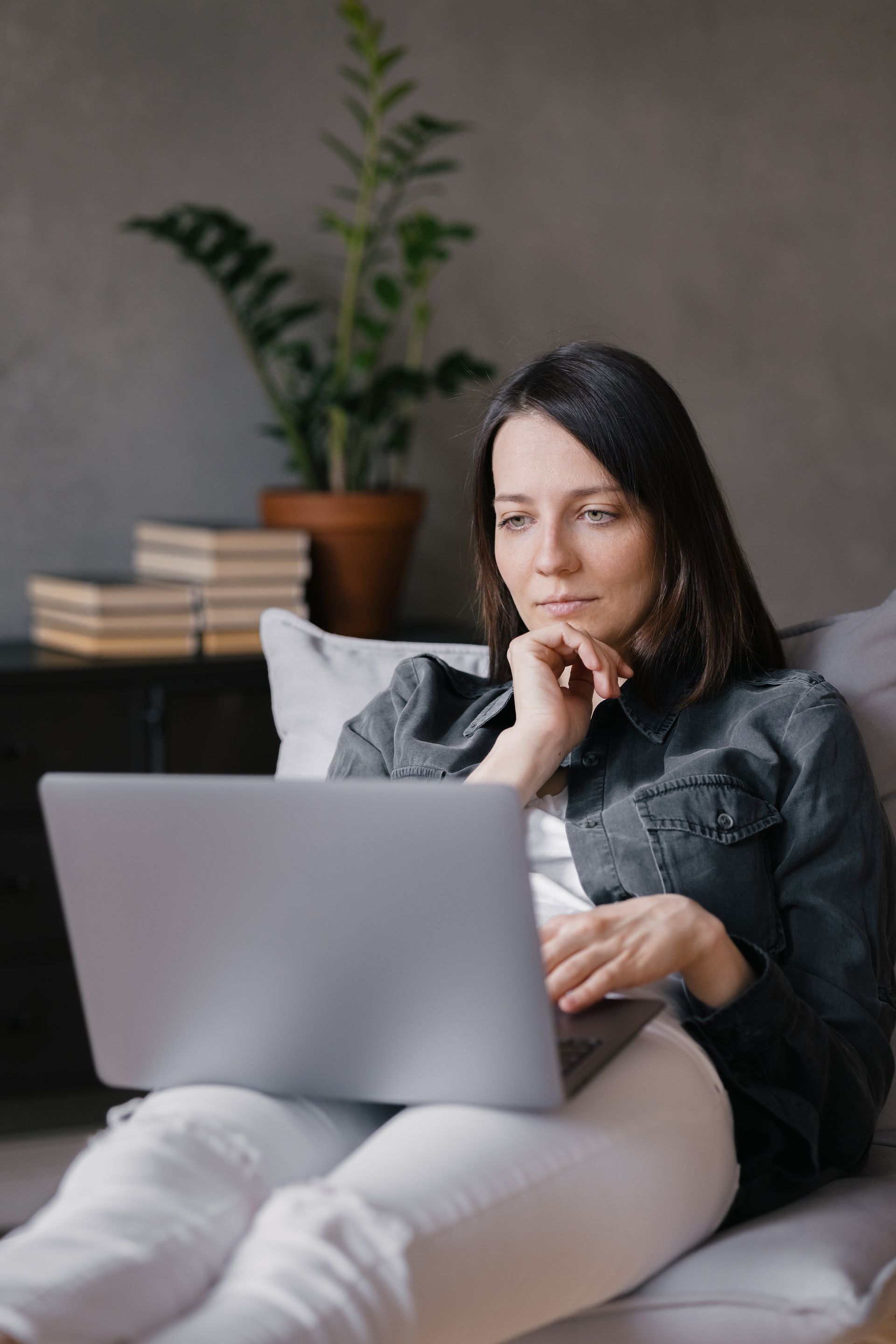 Close-up of a green fan palm leaf with radiating vertical lines, lit by sunlight.