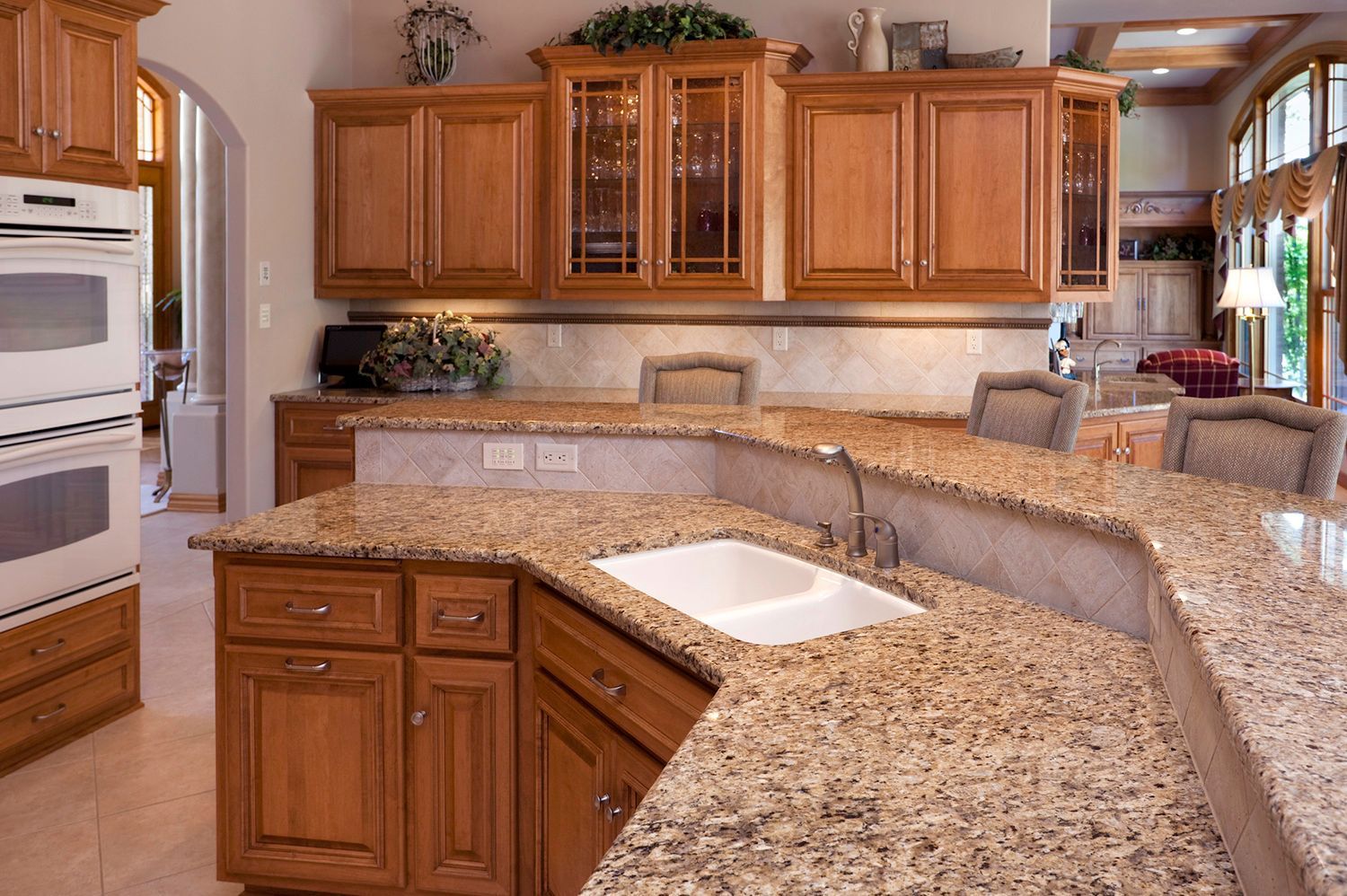 A kitchen with granite counter tops and wooden cabinets