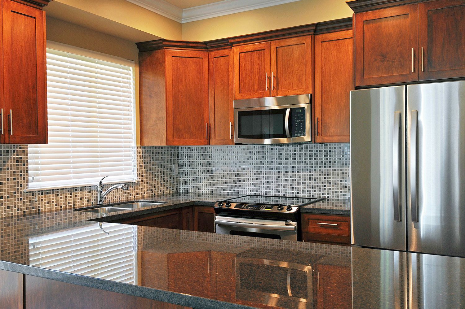 A kitchen with stainless steel appliances and wooden cabinets