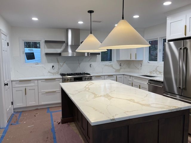 A kitchen sink with a faucet and a window in the background