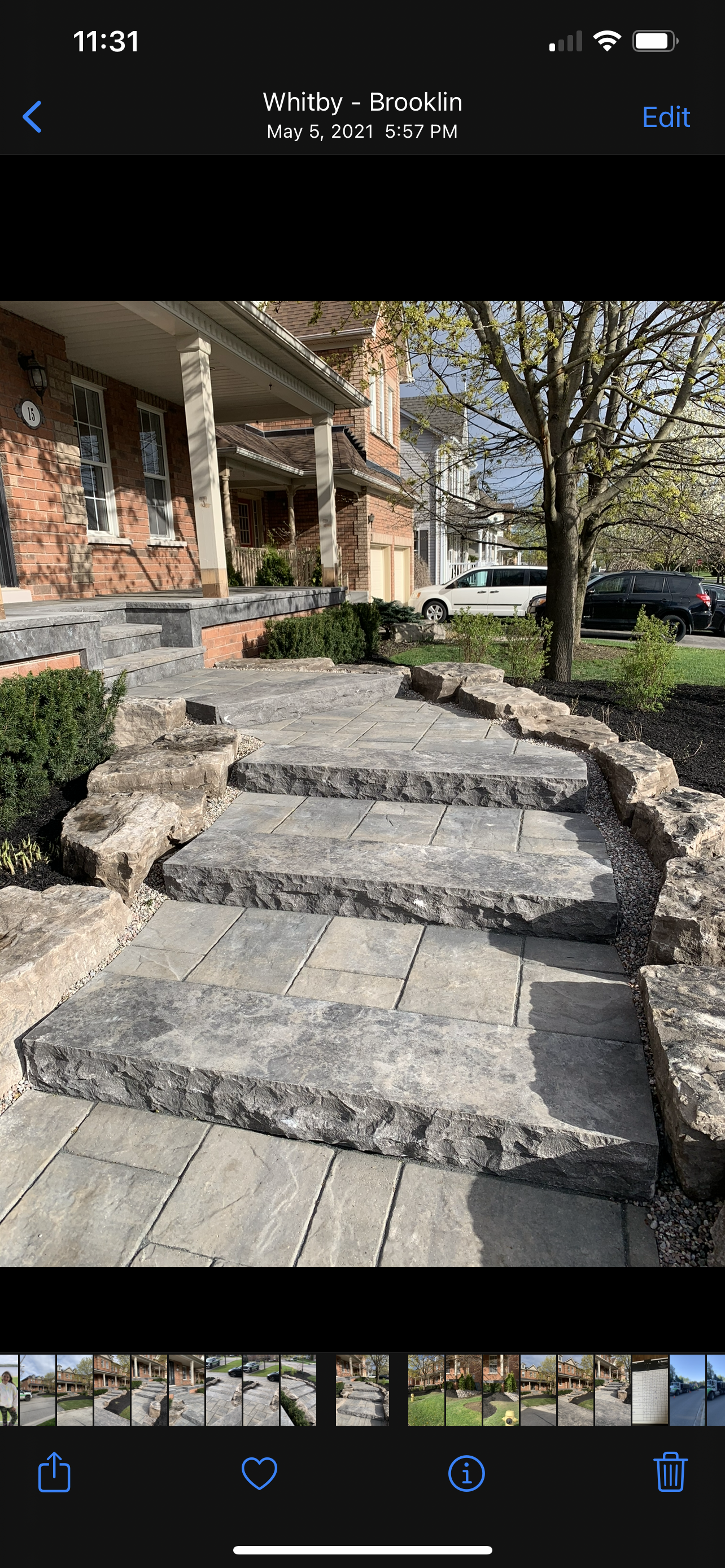 A picture of a stone walkway leading up to a house.