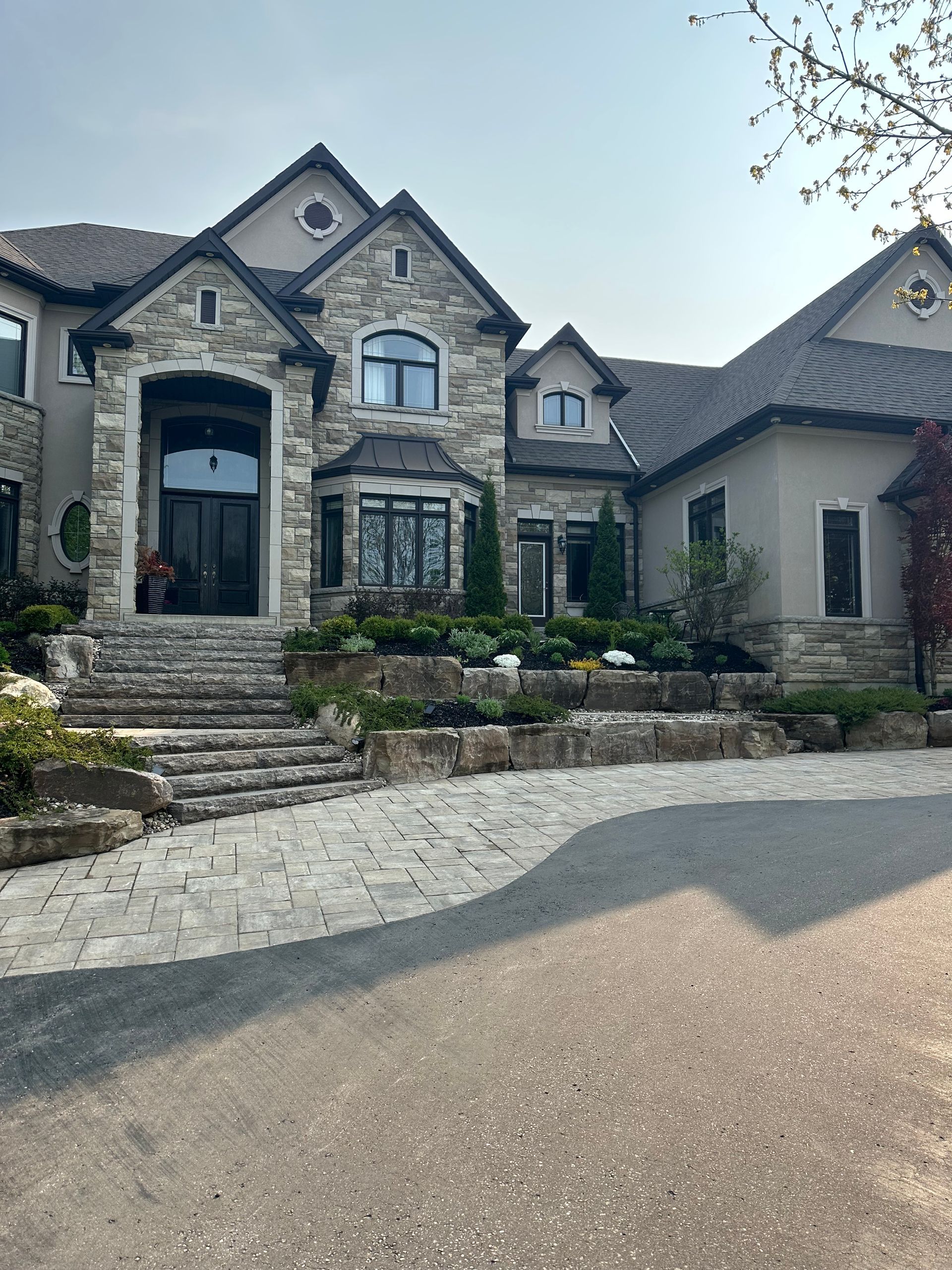 A large house with a driveway in front of it.