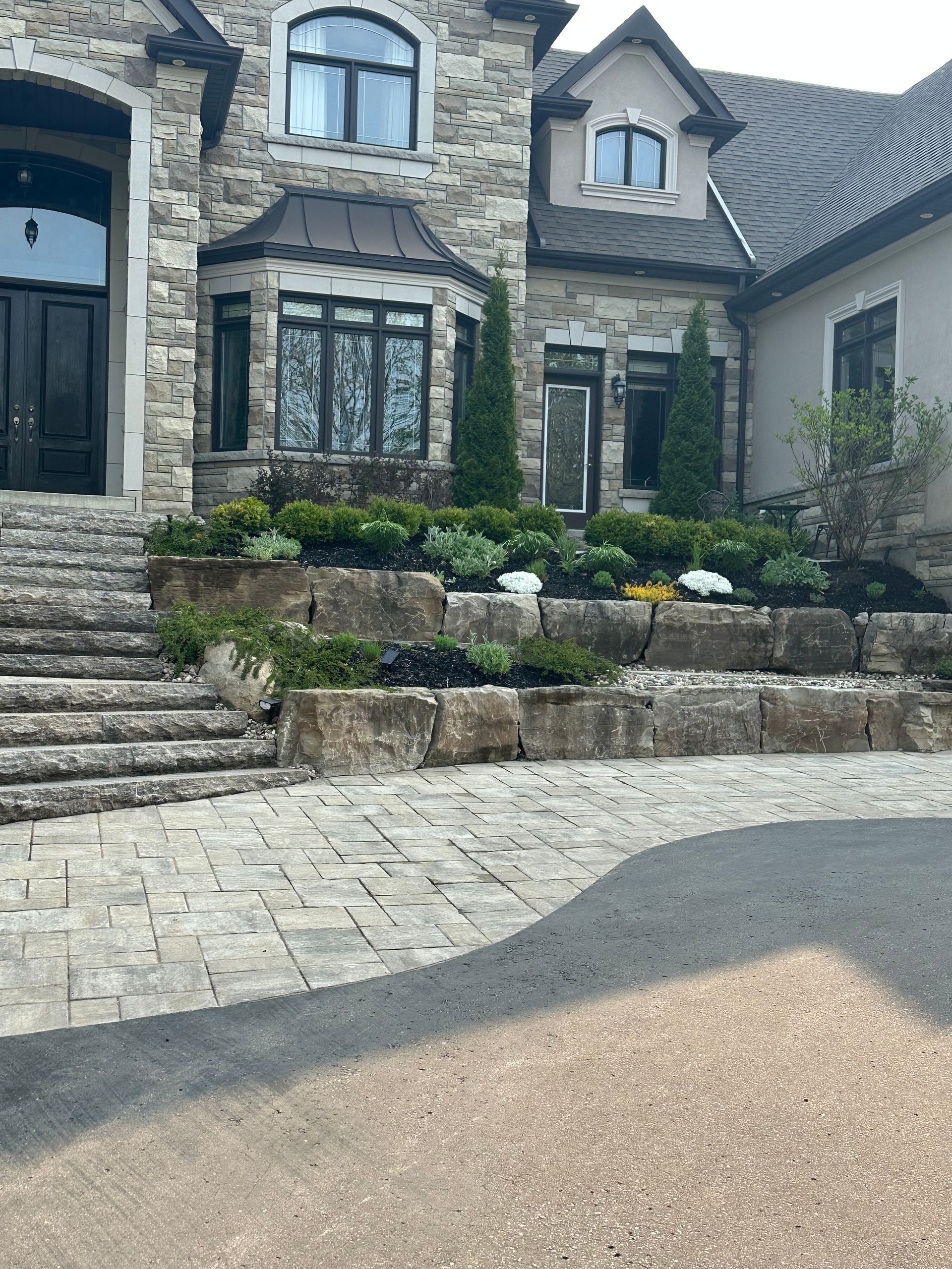 A large stone house with stairs leading up to it