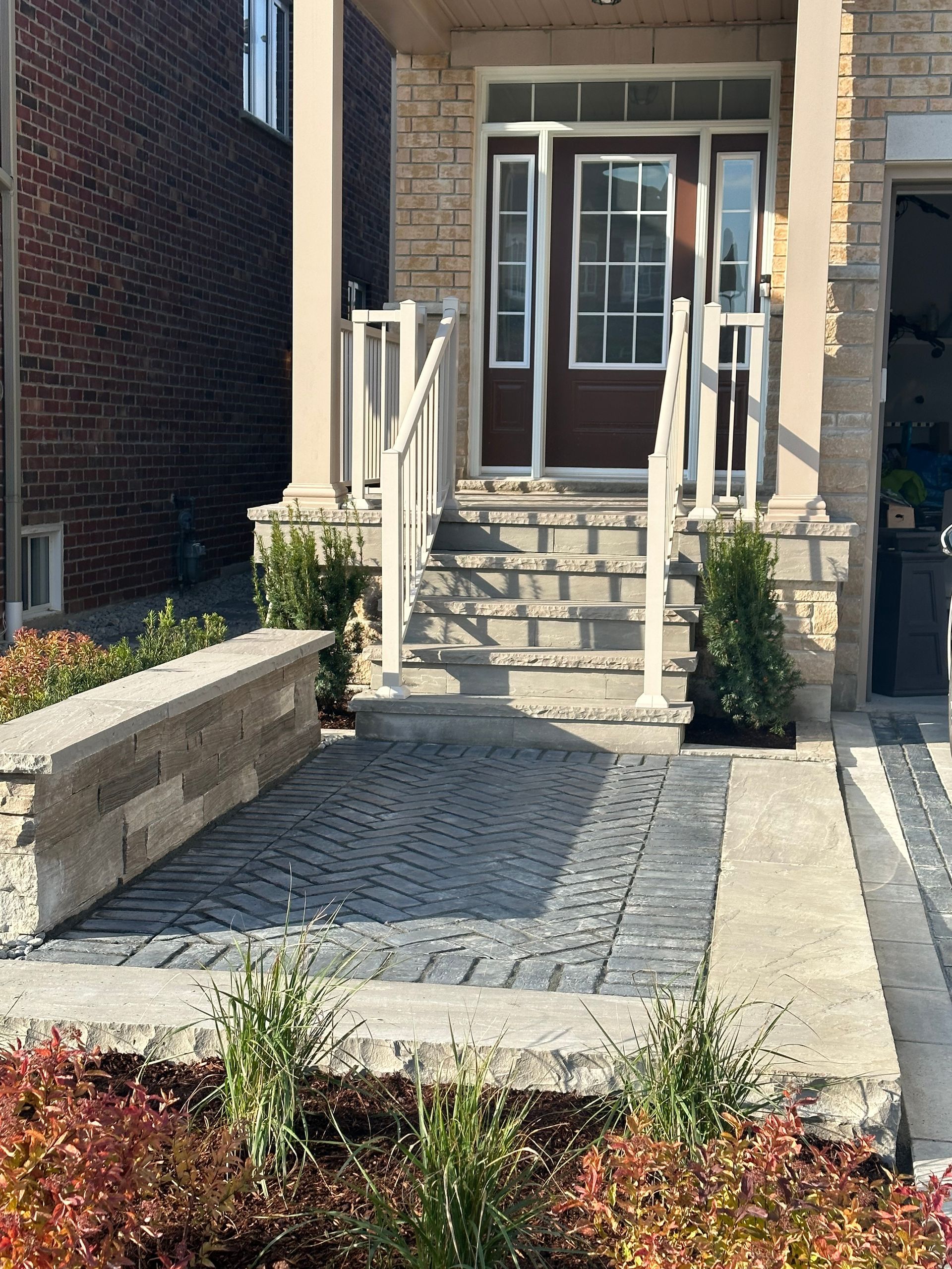 A brick house with stairs leading up to the front door