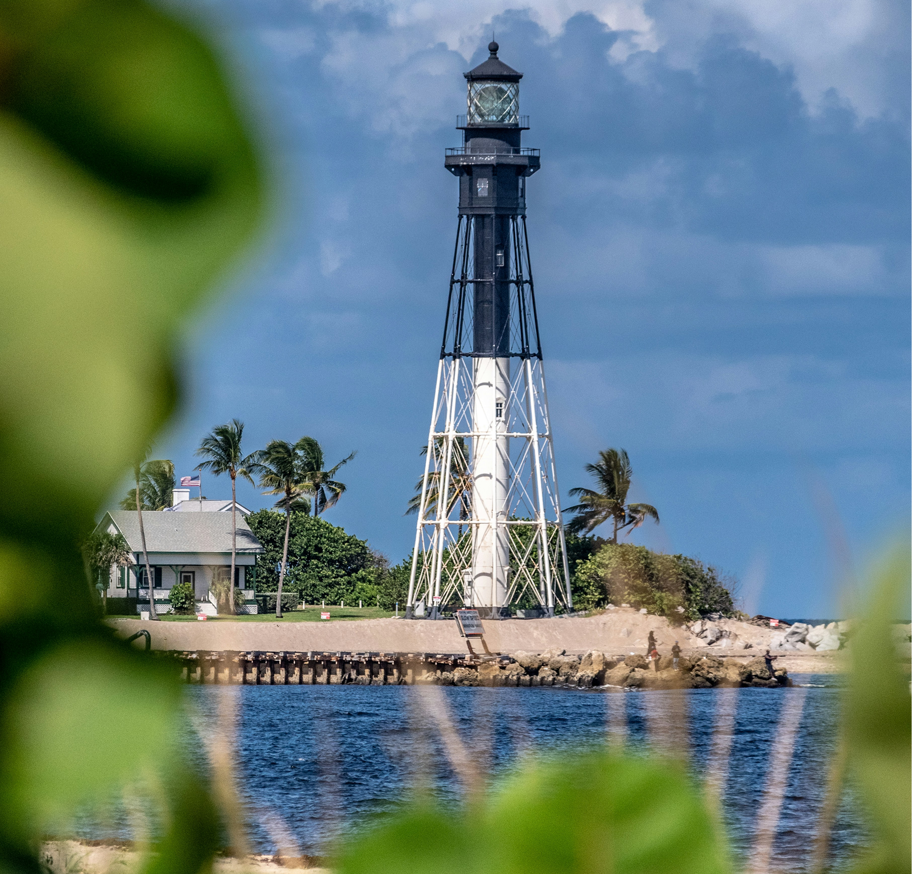 A lighthouse in the middle of a body of water