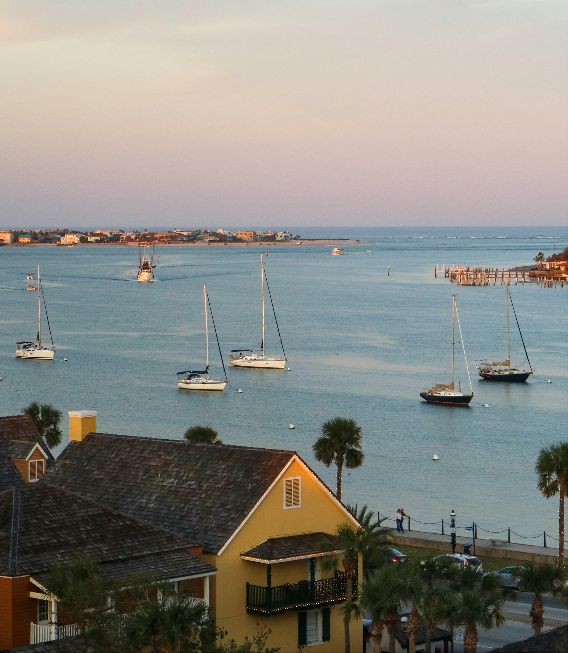 A large body of water surrounded by houses and palm trees
