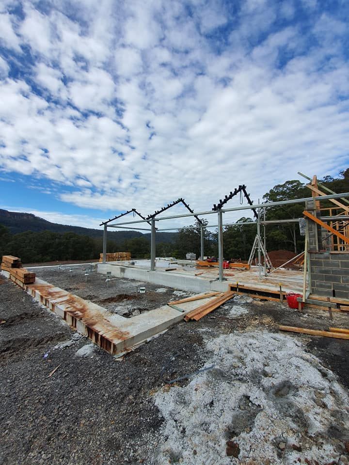 A Large Building is Being Built in the Middle of a Dirt Field — Proweld Steel Fabrication In Southern Highlands, NSW